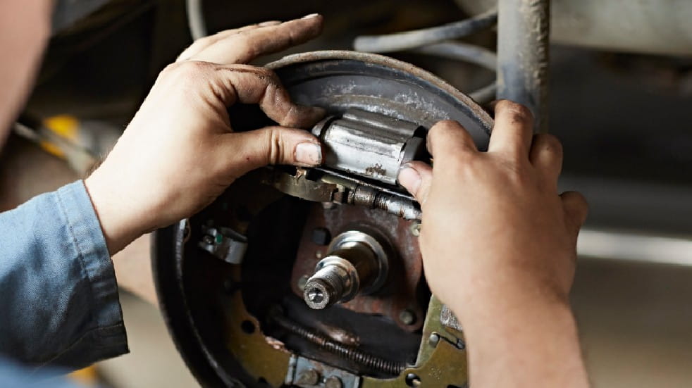 Car maintenance checklist car repairs man fixing car brakes